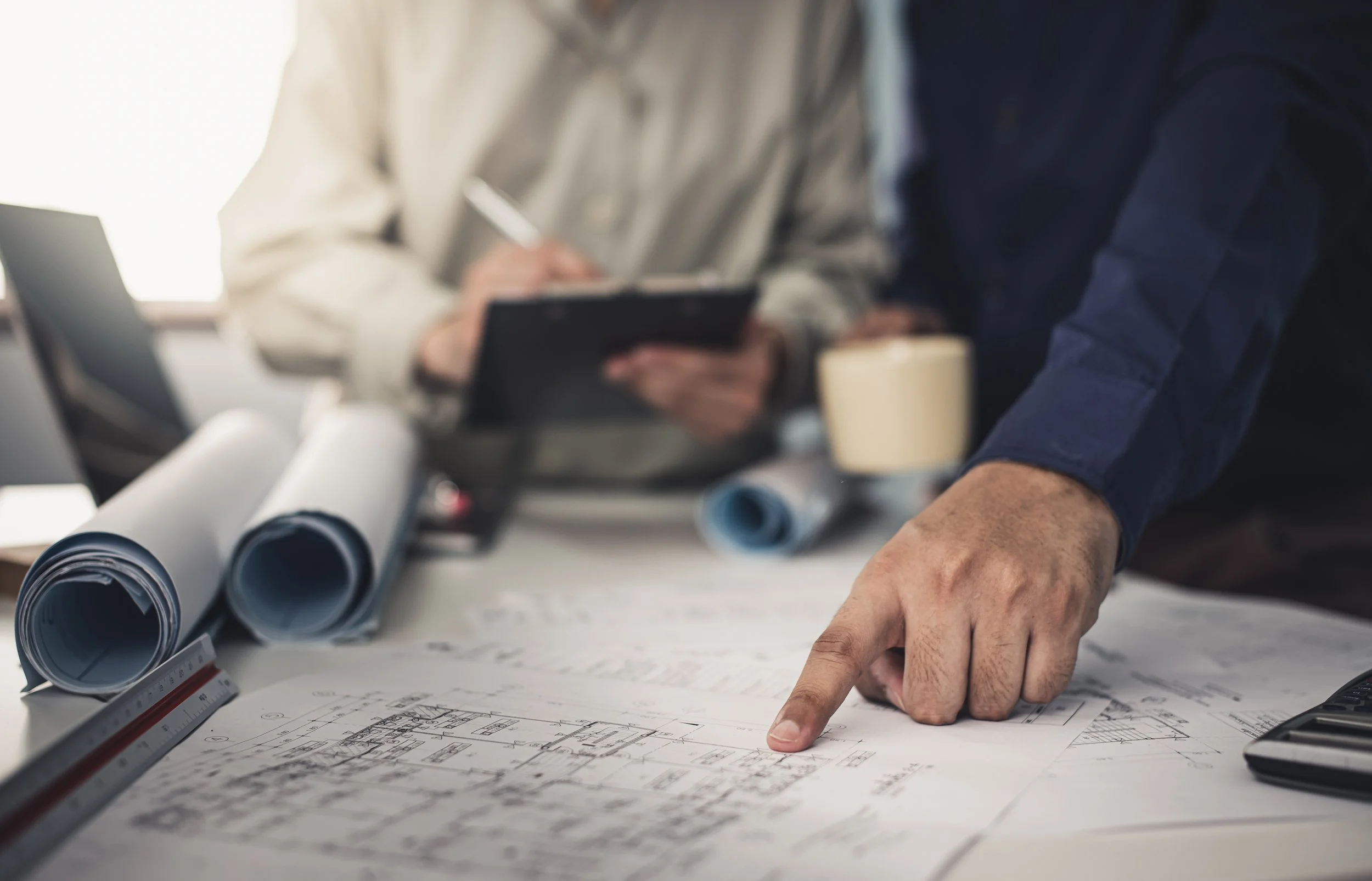 Manufacturing team reviewing drawings and documents for quote preparation